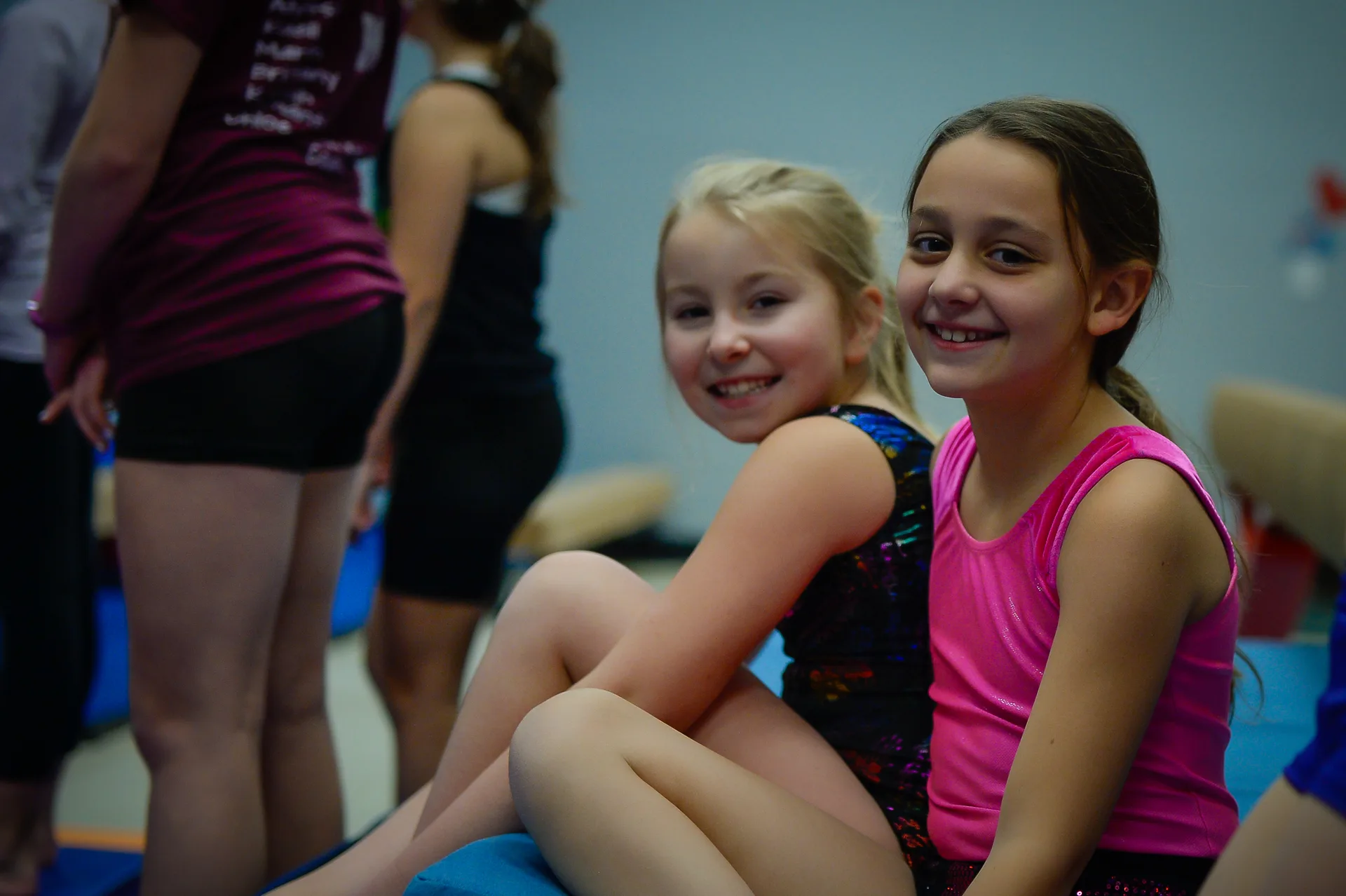 Young gymnasts smiling in the EvolveKids gym